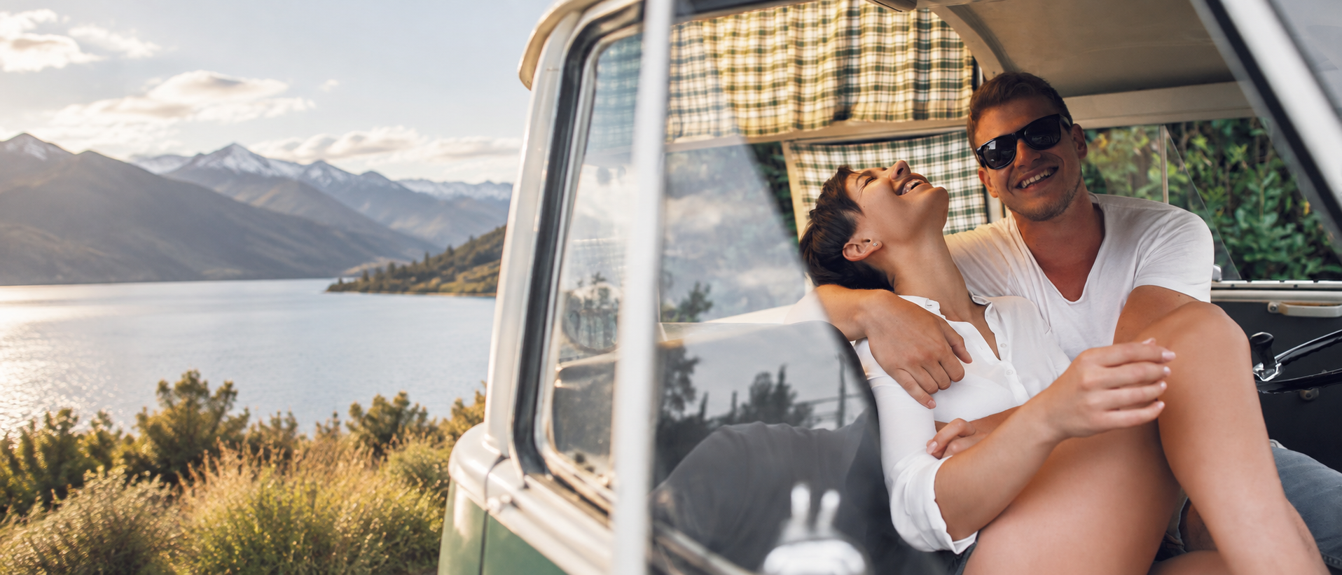A couple enjoying a relaxed moment in a campervan