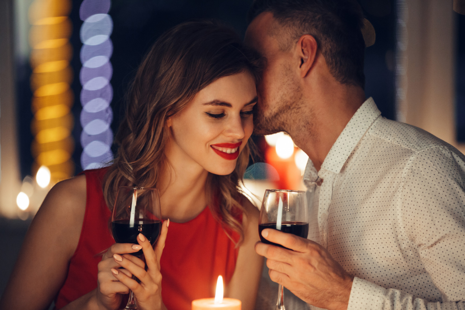A couple enjoying wine together during an Auckland dinner date