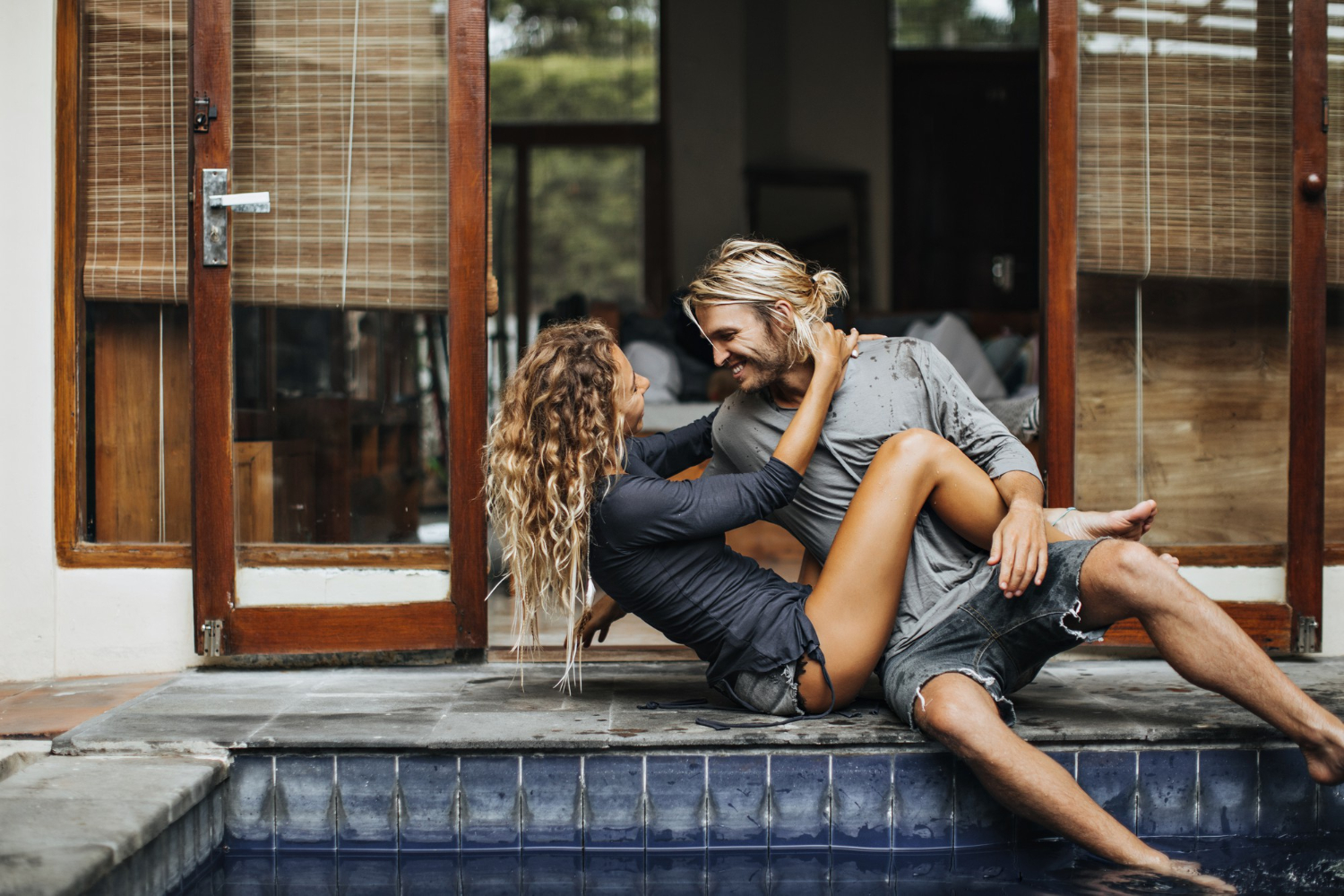 A couple relaxing together beside an Auckland home
