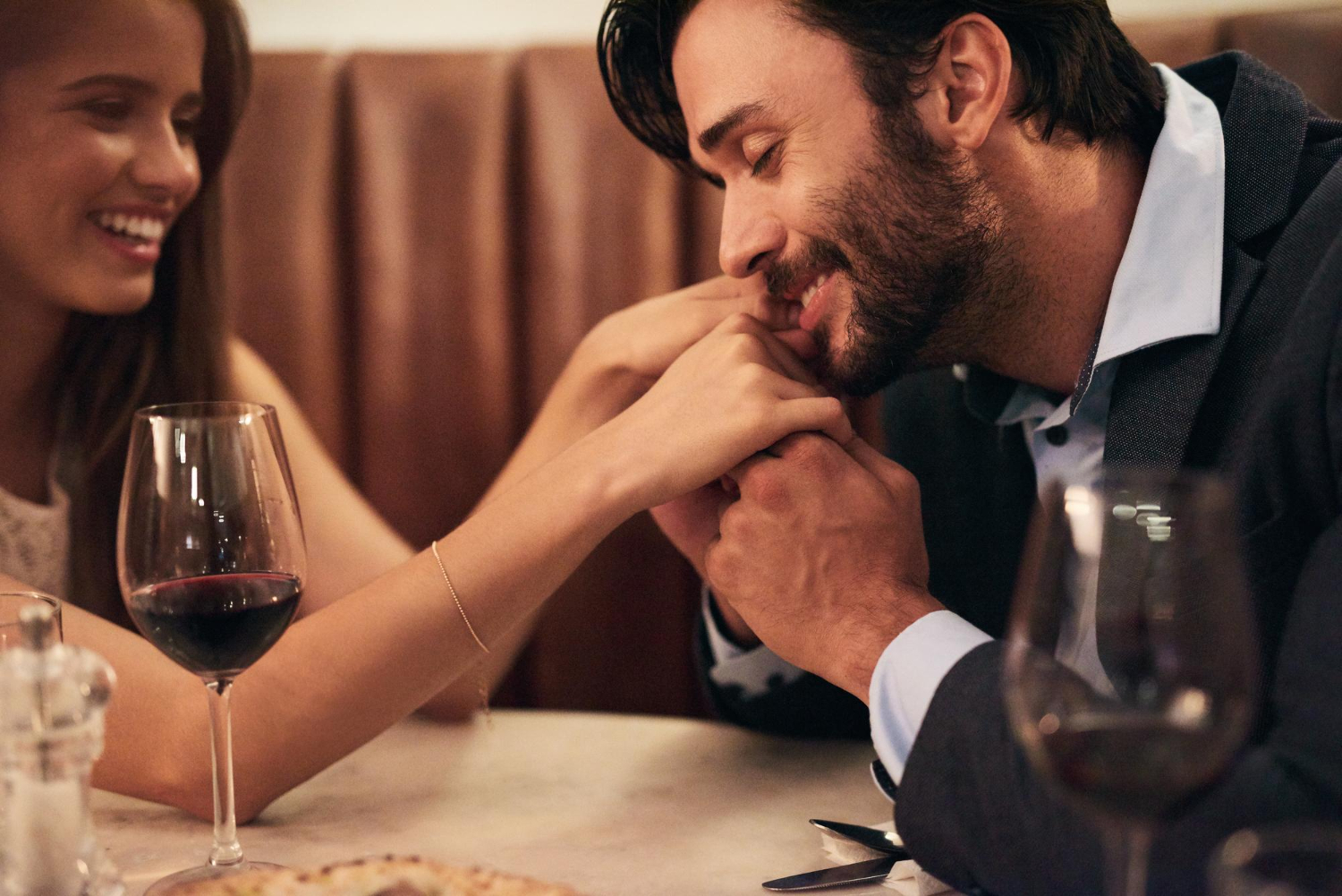 A couple enjoying a warm dinner conversation together